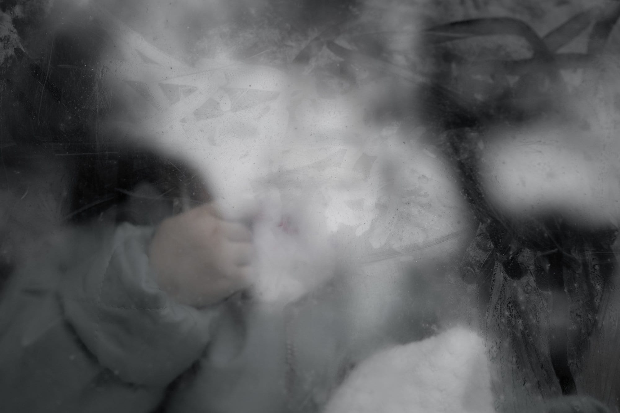 A newborn seen through a blurred surface.