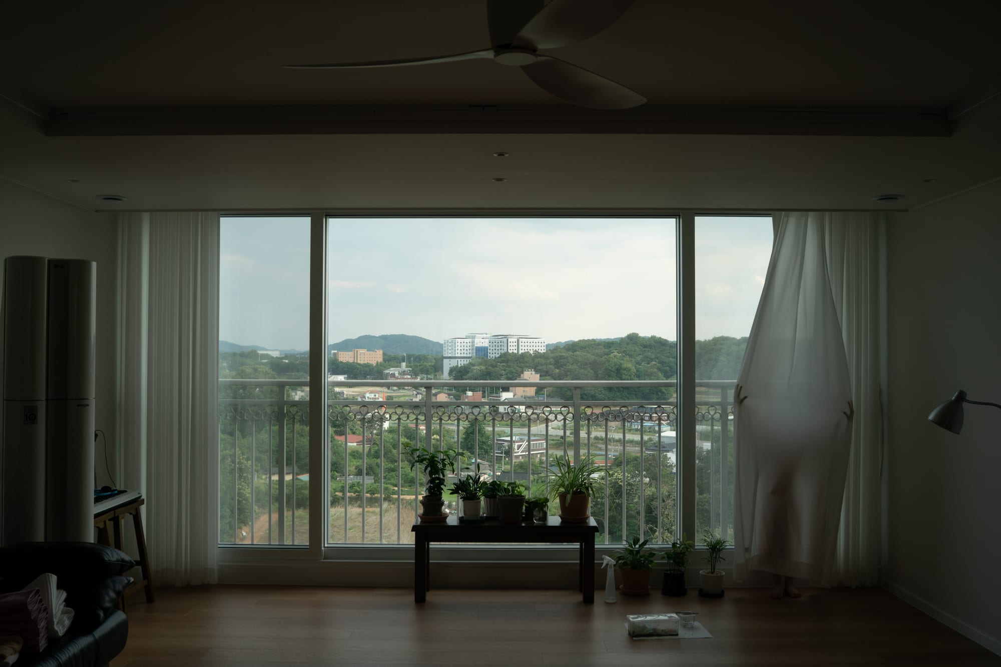 A curtain hangs beside the window.